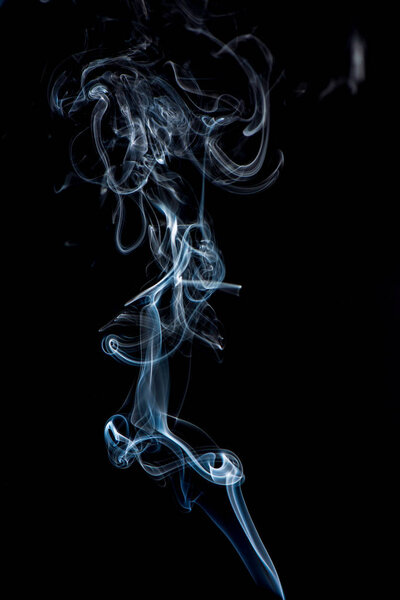 Close up view of white smoke on black background