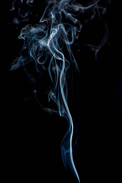Close up view of white smoke on black background