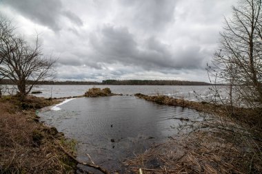 karanlık su ve kirli shore li Letonya, nehir kenarında yatay