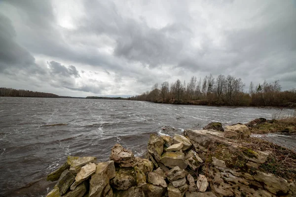 Riverside landscape in latvia with dark water and dirty shore li — Stock Photo, Image