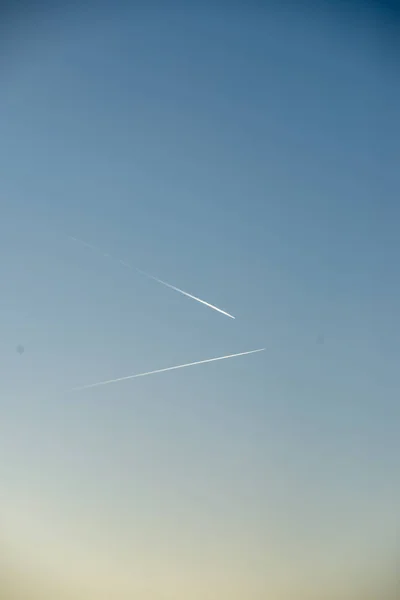 青い空に煙の道を残す飛行機 — ストック写真
