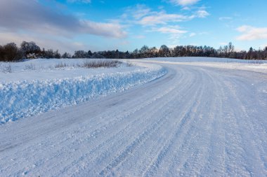 Orman woth mavi gökyüzü buz ve kar kaplı karlı kış yolu