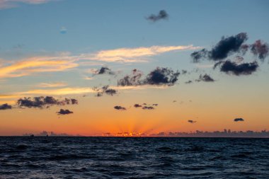koyu kırmızı bulutlar ile deniz gölü üzerinde renkli gün batımı