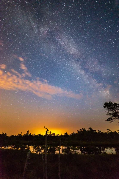 night sky with stars and clouds in long exposure shot