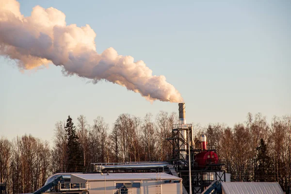 industrial smoke from large chimneys in winter