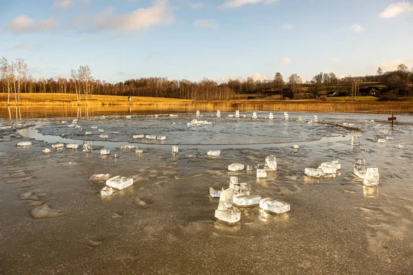 Stukjes bevroren ijs in het meer in een schemerige winterdag — Stockfoto