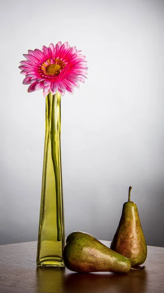 Natuur Morte samenstelling met bloem, vaas en peer op de tafel — Stockfoto