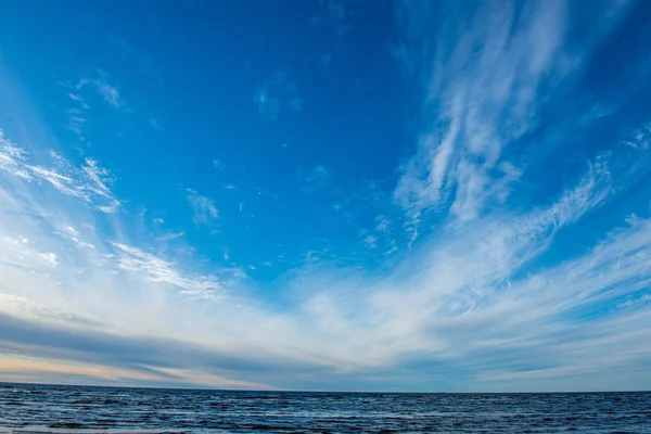 blue sky with white clouds over countryside landscape
