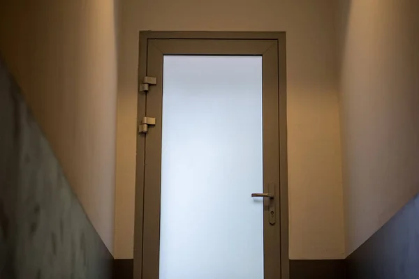 stairway leading to white door in apartment