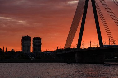 Letonya 'daki Riga şehrinin panoramik görüntüsü. Akşamüstü Letonya 'nın başkenti, kırmızı gün batımı ve Daugava nehri.