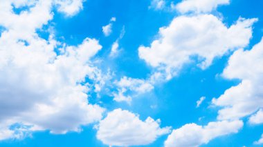 Beyaz kabarık bulutlar ve mavi gökyüzü ile parlak, güzel bir gökyüzü