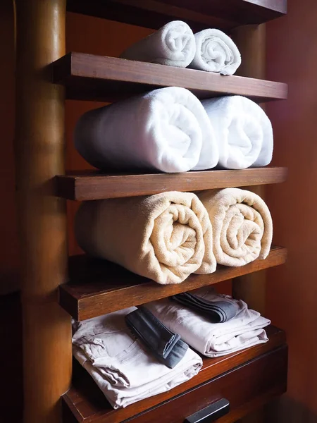 Towel on the shelf, wooden furniture, decorated in the bathroom