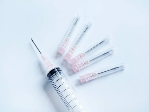 Syringe needle hypodermic injection of sick dog isolated on clean background.