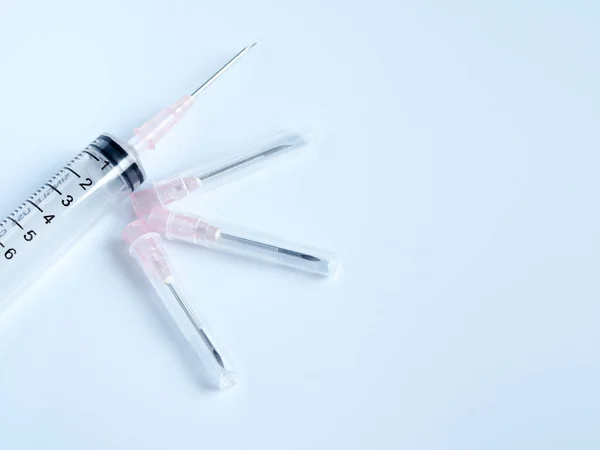 Syringe needle hypodermic injection of sick dog isolated on clean background.