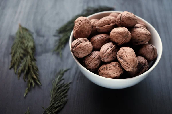 Yukardan gelen fındıklı kase, siyah arka plan.