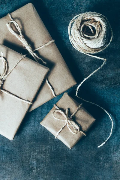 Packages wrapped in kraft paper tied with jute