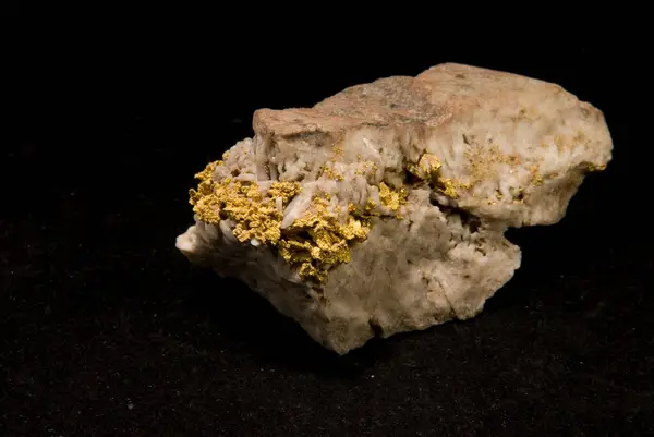 a vein of gold embedded in granite and quartz