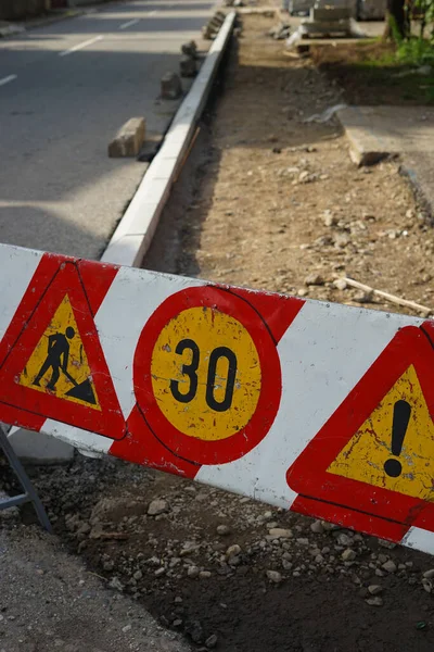 Warning signs for carrying out works on the street. Reconstruction of sidewalk