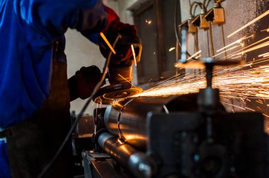 Atölyede materyal işleme. Çelik kaynıyor.