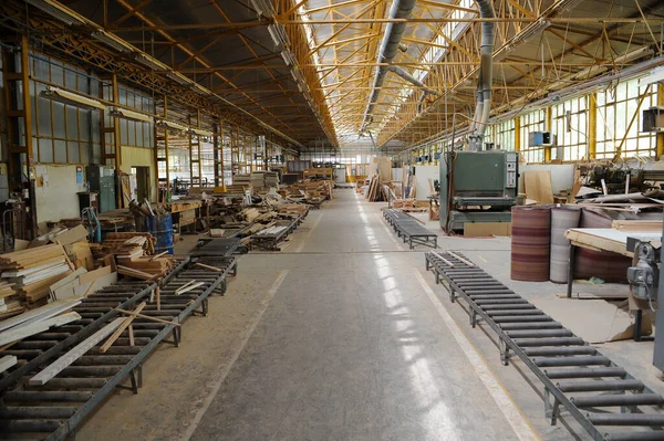 Wood processing machines and pieces of products in a furniture factory