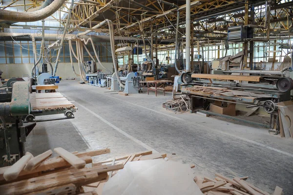 Wood processing machines and pieces of products in a furniture factory