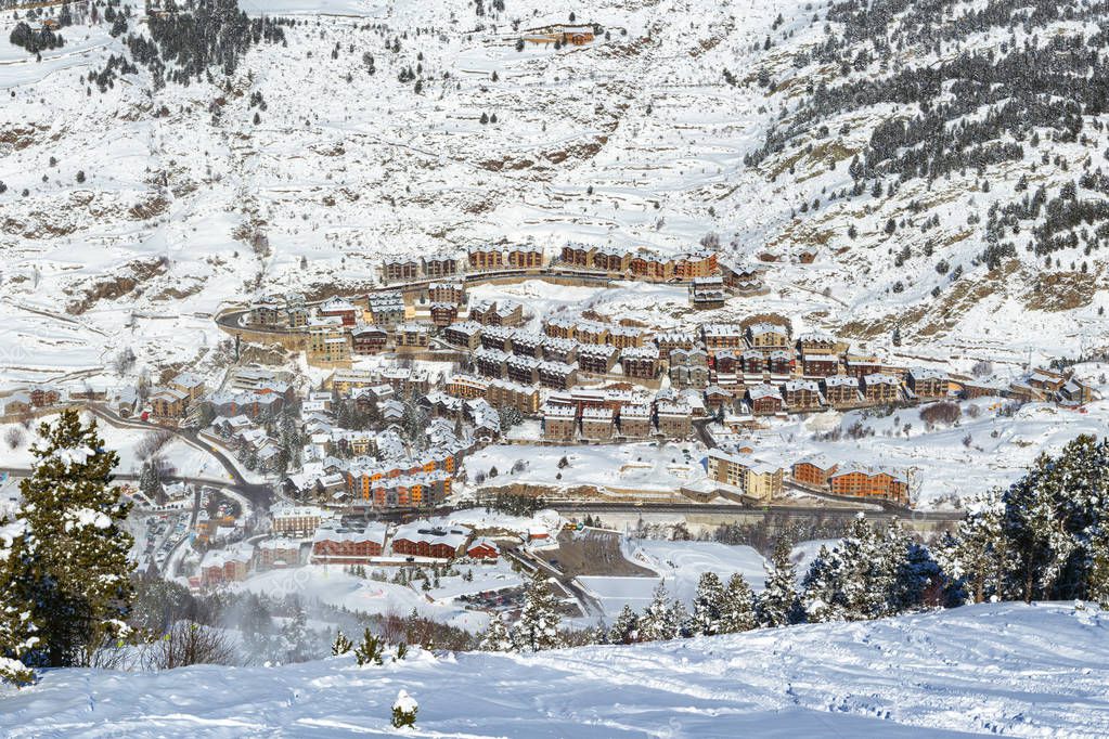 Panoramic view of Soldeu ski resort - El-Tarter in Andorra from a slope in sunny winter day. Buildings and the road in mountains are in the distance visible
