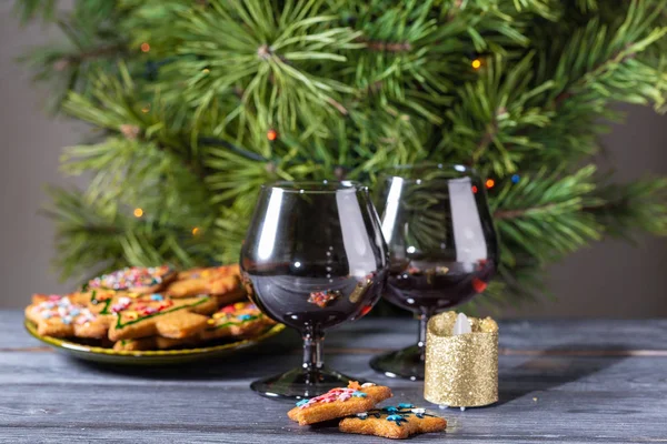 Christmas dessert - a traditional cookie on the background of a green Christmas tree.