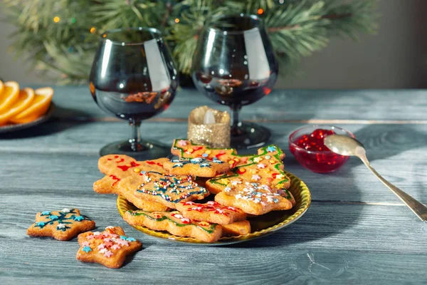 Christmas dessert - a traditional cookie on the background of a green Christmas tree.