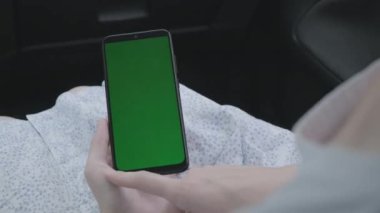 Arabada cep telefonu olan bir kadının elini yakın plan çek.
