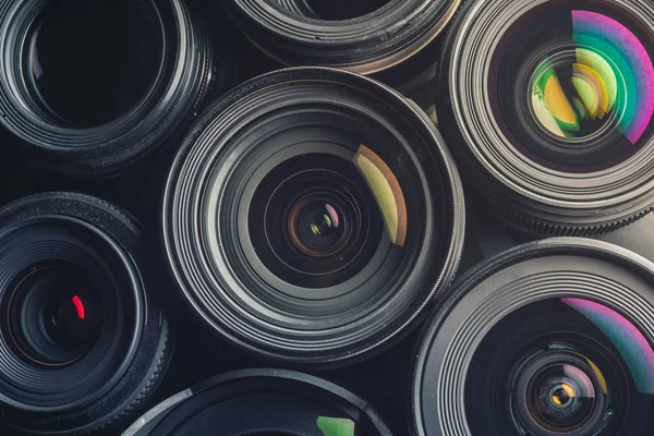 Set of various DSLR lenses with colorful reflections — Stock Photo, Image