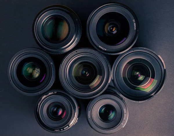 Set of various DSLR lenses with colorful reflections — Stock Photo, Image