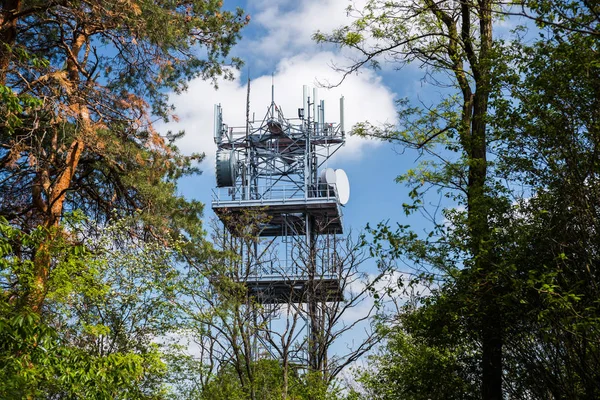 Telecommunication and Communication Tower Antenna, Technology 3G,4G of Industrial Transmission Network. In the forrest.