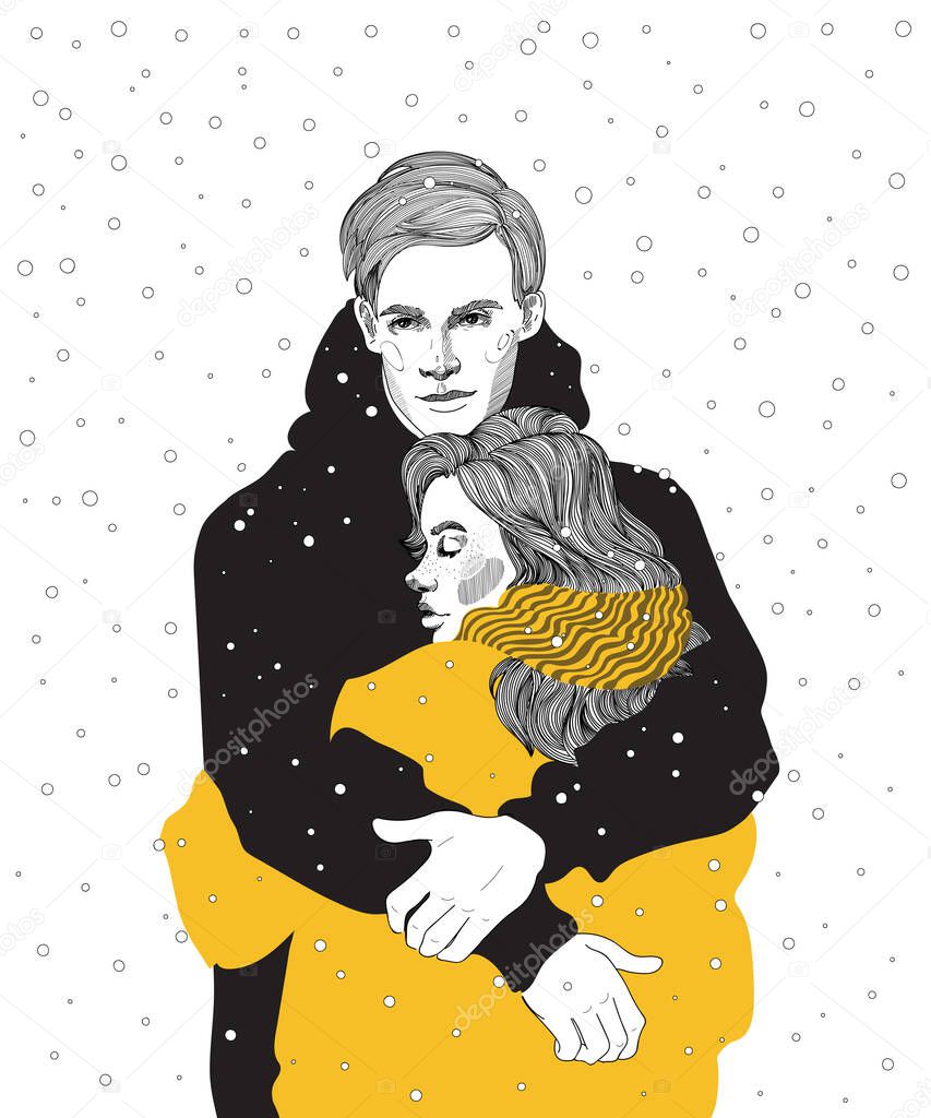 cute young couple in bright down jackets hugs under a snowfall, a meeting, warming hugs