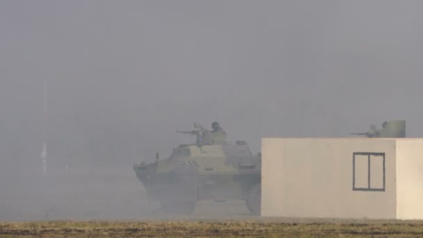 Любовный военный транспорт с пехотинцами прячется от дыма в военном шоу — стоковое видео