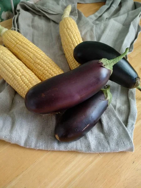 Ripe Purple Eggplants Yellow Corn Leaves Lie Gray Linen Towel — Stock Photo, Image