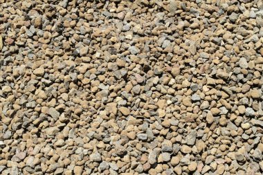 İç dekorasyon ve endüstriyel yapı için taş çakıl taşı dokusu arka planı. Hafif çakıl döşeme dokusu. Yerde kahverengi ve gri çakıl taşı dokusu
