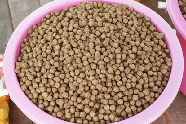 Close up animal food in pink plastic bowl