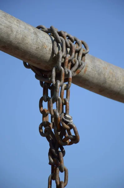 old chain on iron pole