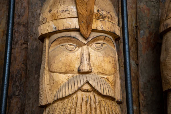 the face of an ancient warrior made of wood