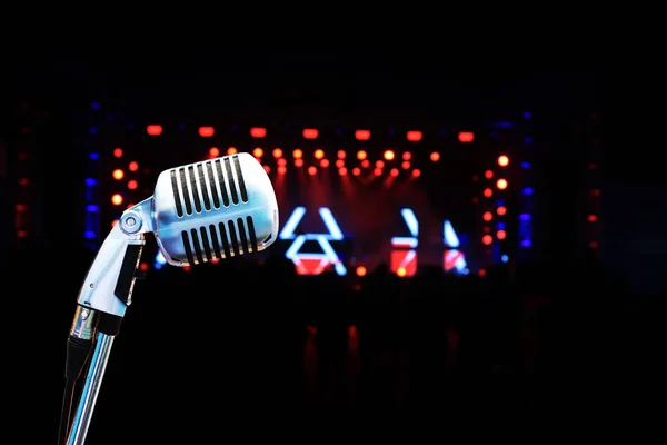 microphone in concert hall with nightclub blur background