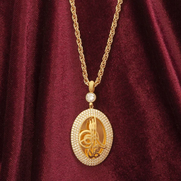 women's gold jewelry drawn on a red velvet fabric