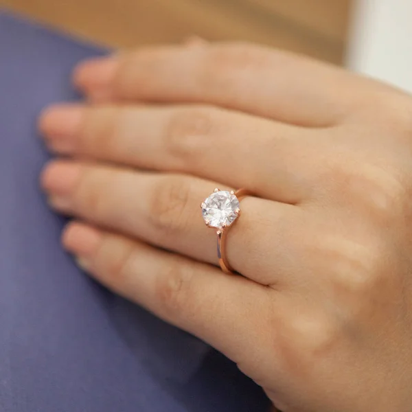 Silver, patterned wedding rings on the female model, different color on the back.