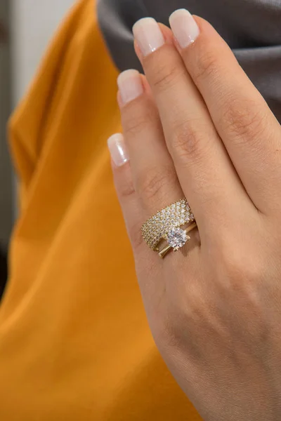 Silver, patterned wedding rings on the female model, different color on the back.