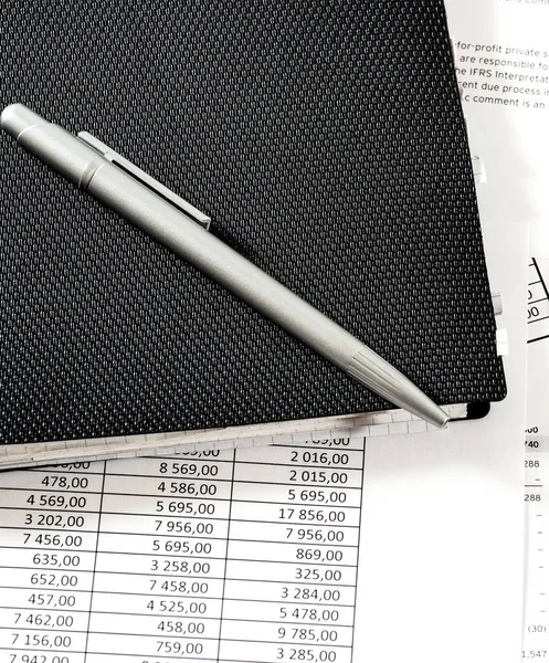 Financial table notepad and pen on the table