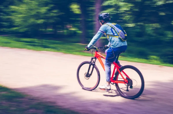 Cyclist Helmet Rides Bicycle Path Motion Blur — Stock Photo, Image