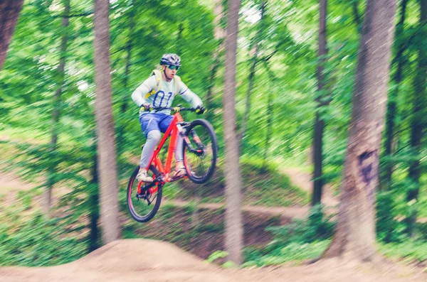 Cyclist Helmet Orange Bike Doing Trick Springboard Jump Forest Motion — Stock Photo, Image
