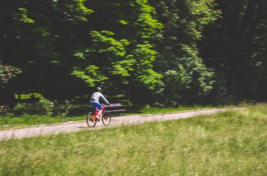 Bir kask bir bisikletçi bir bisiklet yolu, hareket bulanıklığı rides.