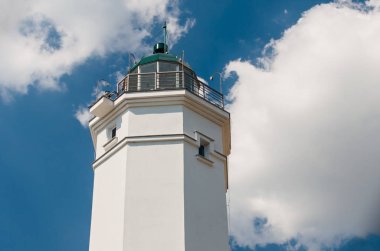 Mavi gökyüzü güneşli bir beyaz deniz feneri.