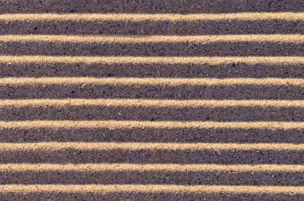 Lines in the sand on the beach, background texture.