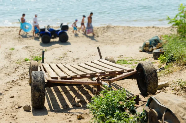 Boat trailer on the sea sandy beach.